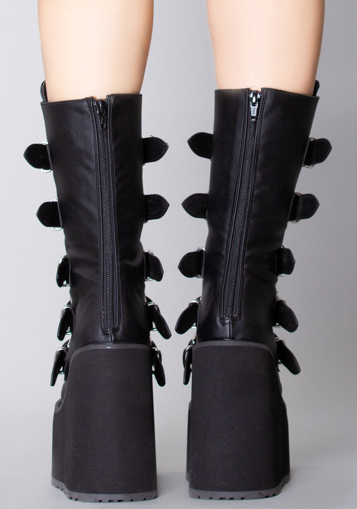 Demonia SWING 230 Black Heart Black Platform Boots in black vegan leather with back zipper closure worn by model — back view