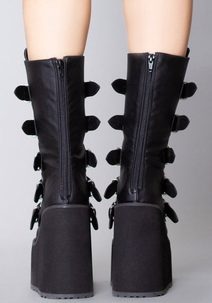 Demonia SWING 230 Black Heart Black Platform Boots in black vegan leather with back zipper closure worn by model — back view
