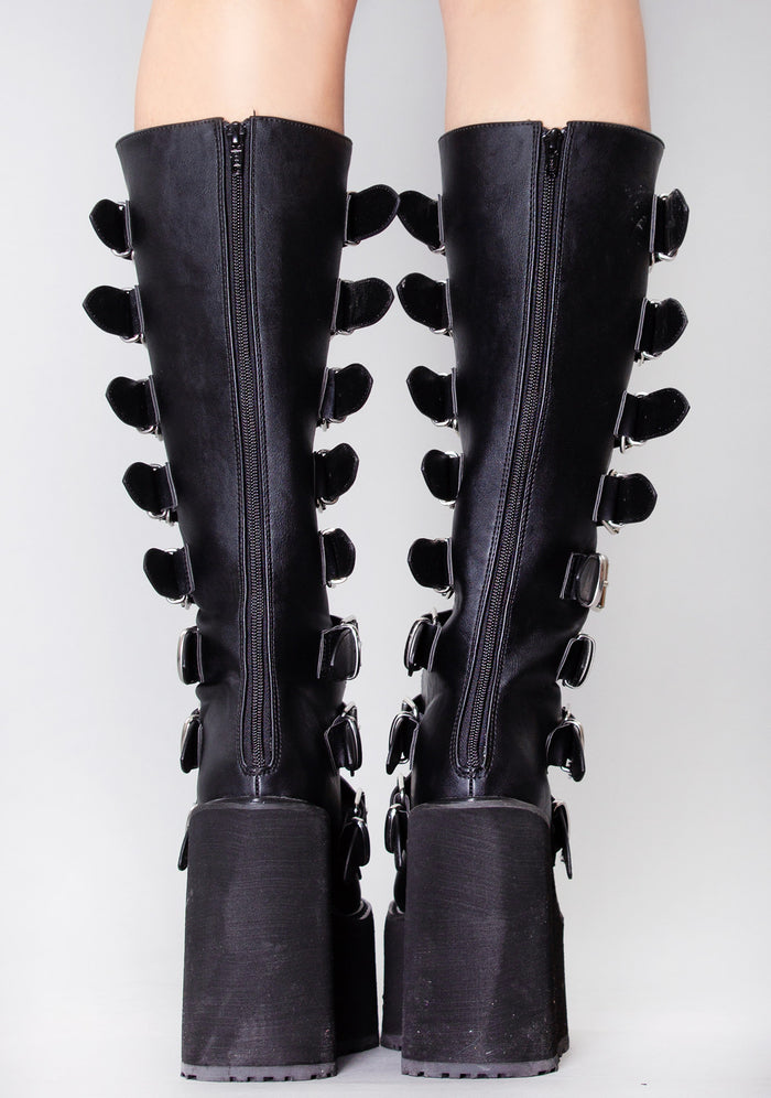 Demonia SWING 815 Beautiful Destruction Black Platform Boots in black vegan PU leather with back zipper closure worn by model — back view