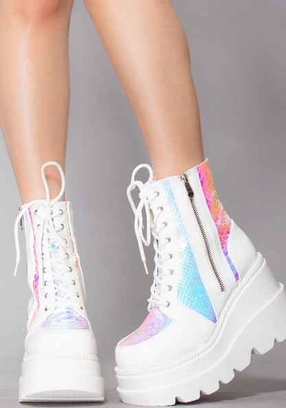 Front view of the white and iridescent RADIO platform boots on-model, showcasing the crisp white laces, secure metal eyelets, and chunky combat boot style toe.