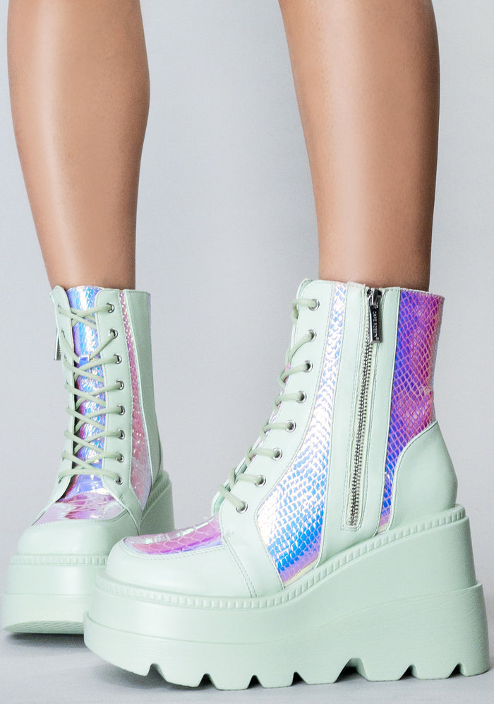 Front view of the exclusive RADIO Prismatic Sage platform boots on-model, showcasing the mint green laces, secure metal eyelets, and lightweight chunky combat boot silhouette.