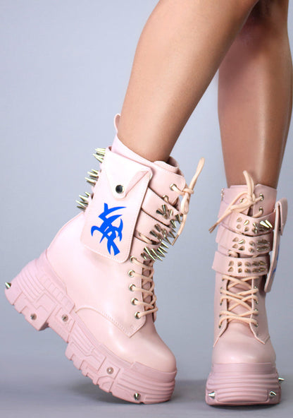 On-foot side angle view of Anthony Wang X WTF CV Chem Baby Metal Pink platform mid-calf boots showcasing the triple spiked buckle straps and blue line graphic details