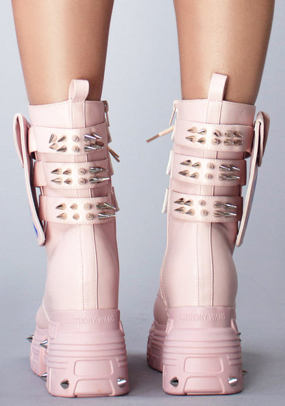 On-foot rear view of Anthony Wang X WTF CV Chem Baby Metal Pink platform boots highlighting the thick heel structure, high traction tread blocks, and metallic spike accents on the heel counter